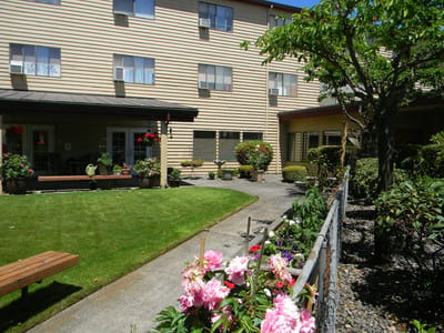 Outdoor garden area with seating and flowers