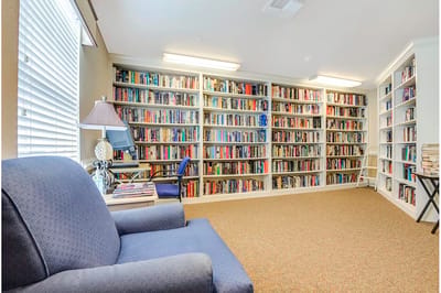 Cozy reading nook with bookshelves filled with books