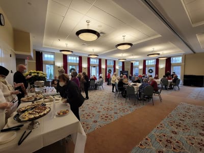 Residents enjoying a gathering with refreshments in a common area