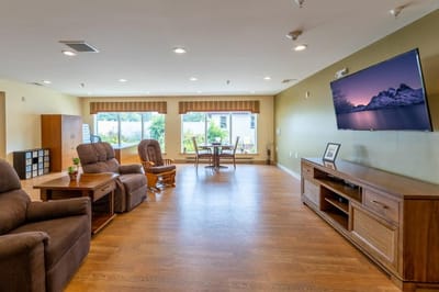 Spacious lounge area with comfortable seating and windows