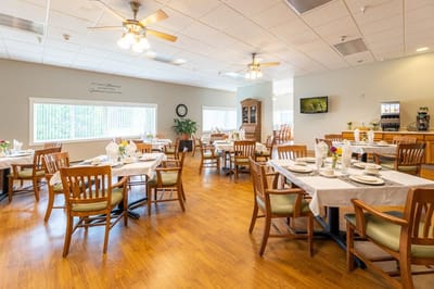 Bright dining room with tables set for meals