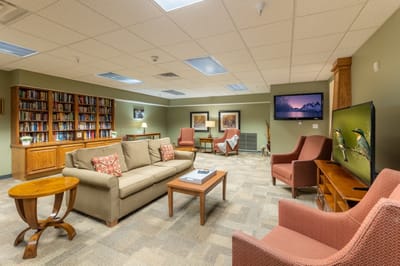 Cozy common area with seating and bookshelves