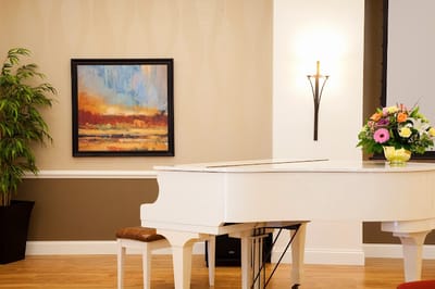 Interior common area featuring a white piano and flowers