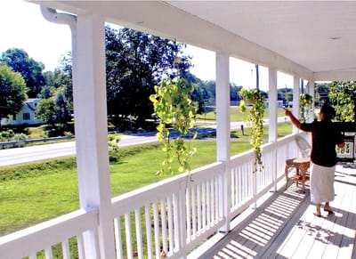 Resident interacting with plants on a porch