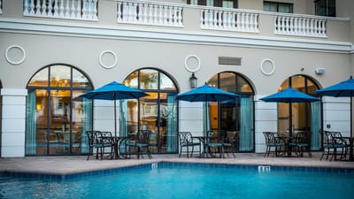 Outdoor pool area with seating and umbrellas
