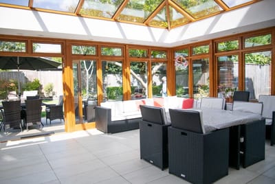 Bright sunroom with seating and views to an outdoor garden