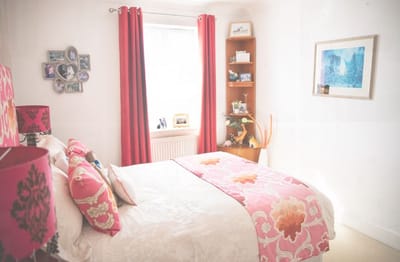 A cozy bedroom with floral decor and natural light