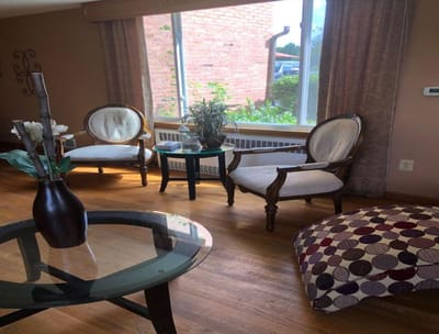 A cozy common area with seating and plants