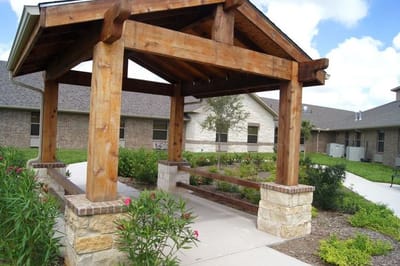 Covered seating area in a landscaped garden