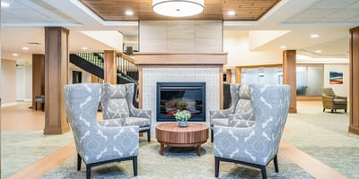 Interior common area with cozy seating around a fireplace