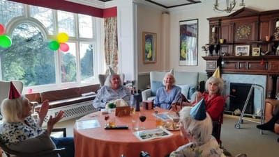 Residents celebrating at a festive gathering with hats
