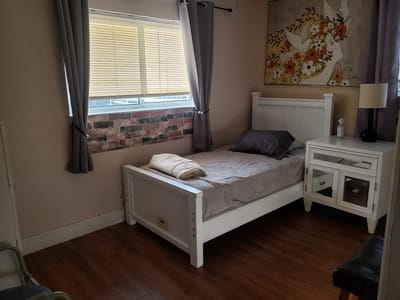Cozy private resident room with bed and decor