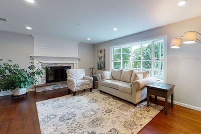 Bright common area with seating and a fireplace