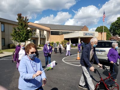 Residents walking outside the facility, enjoying the day