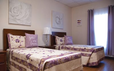 Cozy resident room with twin beds and decor