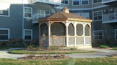 Outdoor gazebo surrounded by landscaped area