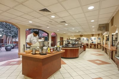 Dining area with a chef preparing food
