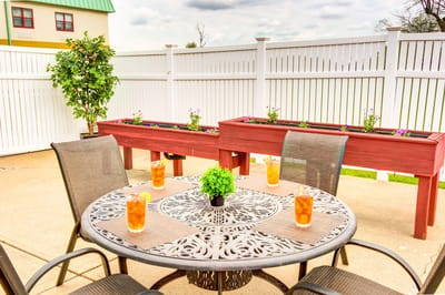 Outdoor seating area with drinks and planters