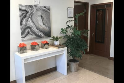 Bright, welcoming interior entryway with decor and plants
