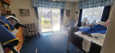 A cozy resident room with sunlight streaming in
