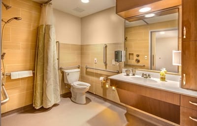 Brightly lit bathroom with safety features and modern design