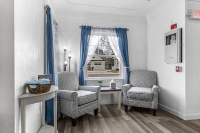 A cozy common area with chairs and natural light