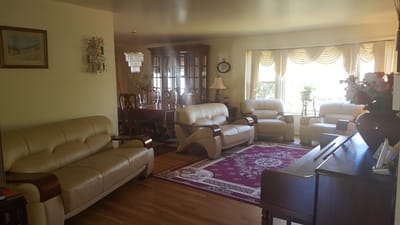 Bright common area with comfortable seating and a dining table