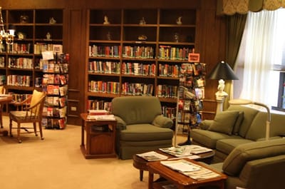 Interior of a cozy library with bookshelves and seating