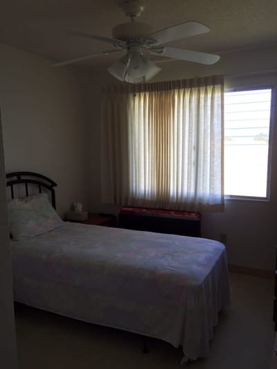 Simple private resident room with a bed and window