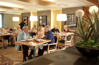 Residents enjoying a meal in the dining room