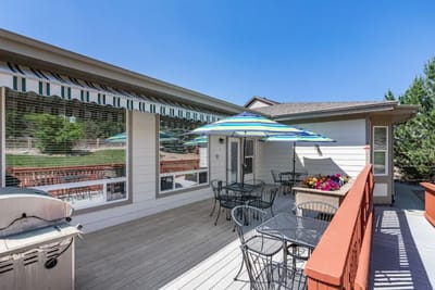 Outdoor seating area with umbrellas at Parker Wagontrail Court