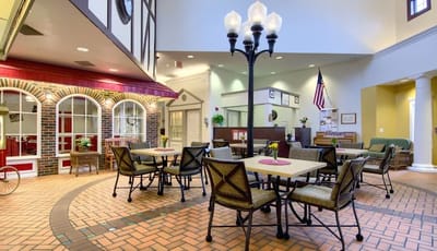 Common area with tables and seating in a senior living facility