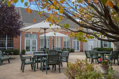 An outdoor seating area with tables and umbrellas