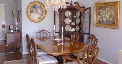 Elegant dining room with wooden table and antique decor