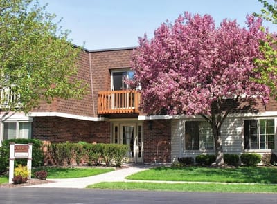 Exterior view of the facility with flowering tree