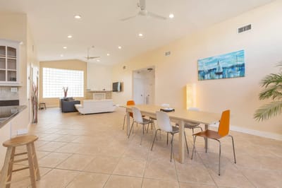 Bright and spacious common area with seating and dining table