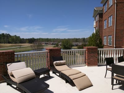 Outdoor patio area with lounge chairs and scenic view