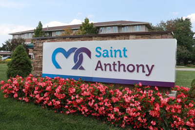 Facility logo sign with flowers in the foreground