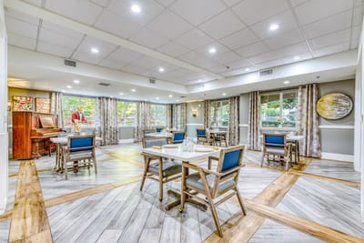 Bright common area with seating and piano