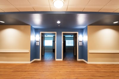 Interior hallway with two doors and lighting