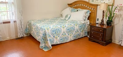 Cozy private resident room with a bed and nightstand