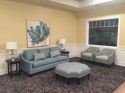 Cozy lounge area with seating and artwork
