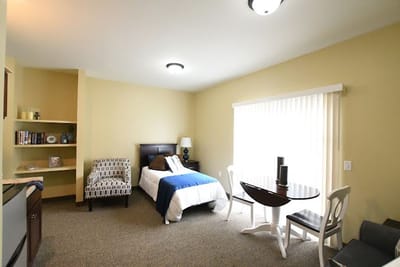 Cozy resident room with bedding and seating area