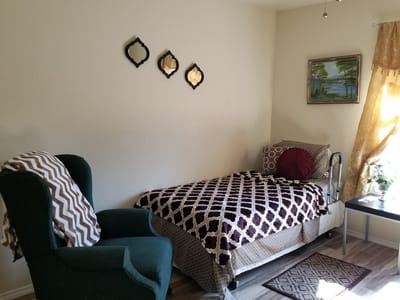 Cozy resident room with a bed and chair