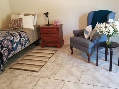 Cozy private room with bed and chair