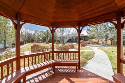 Wooden gazebo overlooking gardens and pathways