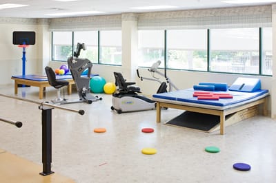 Rehabilitation exercise area with equipment and colored mats