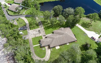 Aerial view of a senior living facility surrounded by greenery