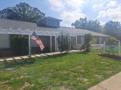 Exterior view of an assisted living facility with a flag