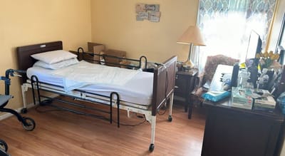 Interior view of a resident room with a bed and desk